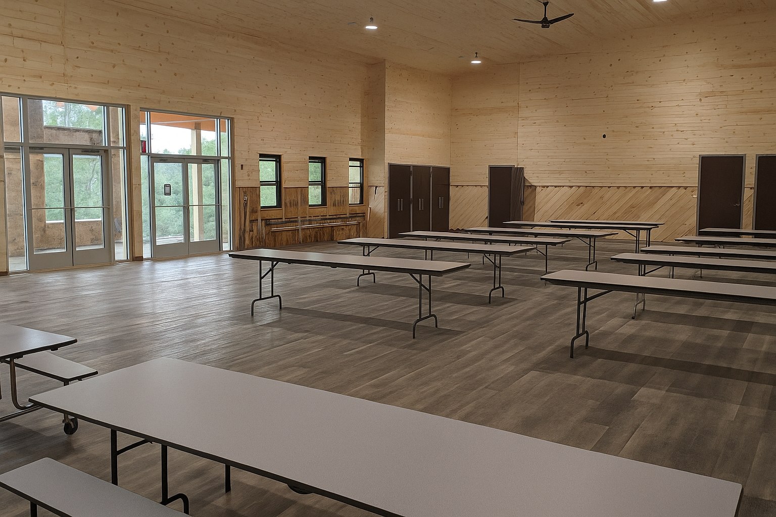 Wood-paneled dining and gathering hall at the retreat property