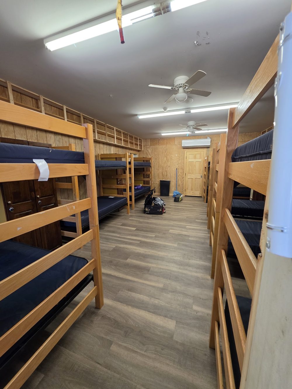 Camp-style bunk room where guests sleep